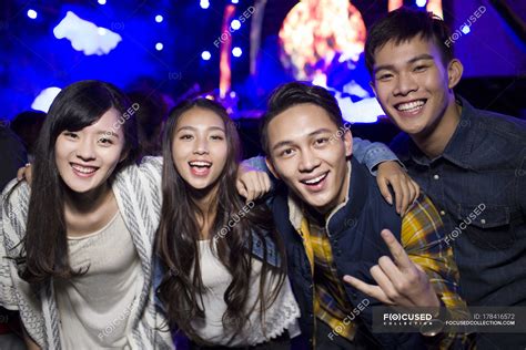 Chinese friends embracing and gesturing at music festival — nightlife ...