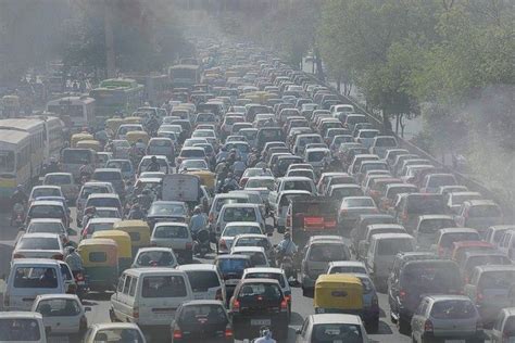 many cars and trucks are stuck in traffic on a busy street, with smoggy ...