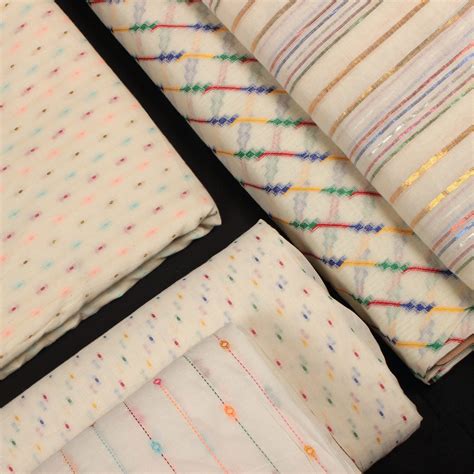 The cotton dobby butta & lurex stripes texture woven into fabric in multicolored hues. These ...