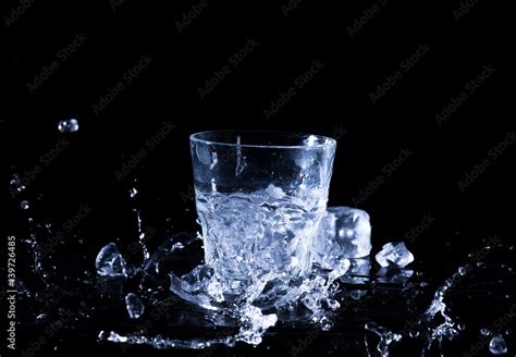 Water splash in a glass. A glass of cold water. Cold water with ice ...