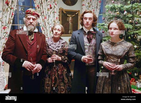 THE MAN WHO INVENTED CHRISTMAS, from left: Jonathan Pryce, Ger Ryan, Dan Stevens as Charles ...