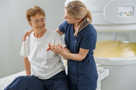 Premium Photo | Doctor radiologist help to patient sit after procedure ...