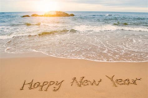 Write Happy New Year On Beach Stock Photo - Image: 63385754