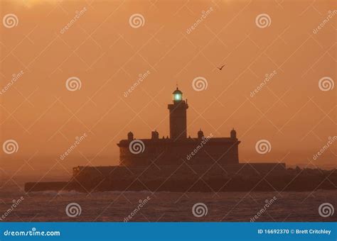 Lighthouse at Sunrise stock photo. Image of dawn, silhouette - 16692370