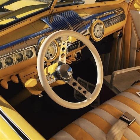 the interior of an old car with yellow and black stripes on it's dashboard