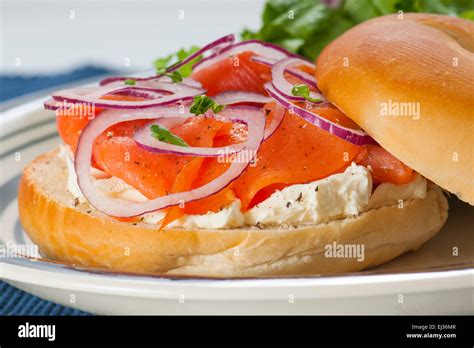 Bagel with Smoked Salmon Lox, cream cheese and red onion accompanied Stock Photo: 79976423 - Alamy