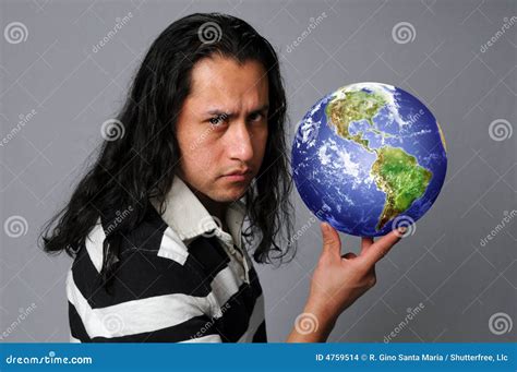 Man holding world in hand stock photo. Image of staring - 4759514