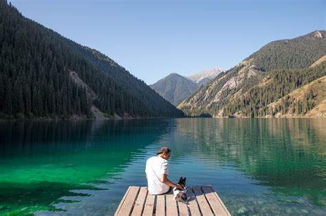 Tourists admiring the view of Kolsai Lakes National Park in Kazakhstan ...