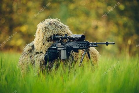 Sniper in camouflage suit looking at the target Stock Photo by ©kaninstudio 62974461