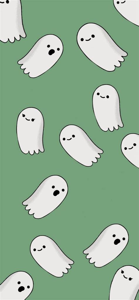 a group of white ghost faces on a green background