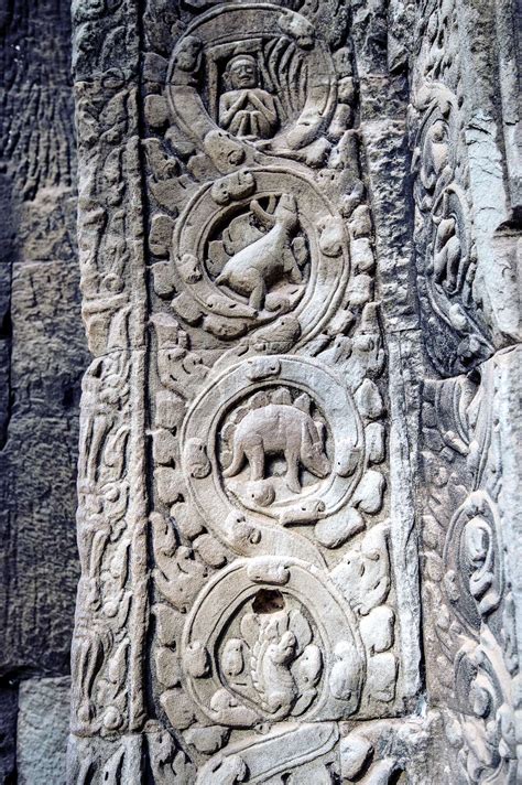 sculpted stone depicting a dinosaur at the ancient Ta Prohm temple at Angkor Wat, Siem Reap ...