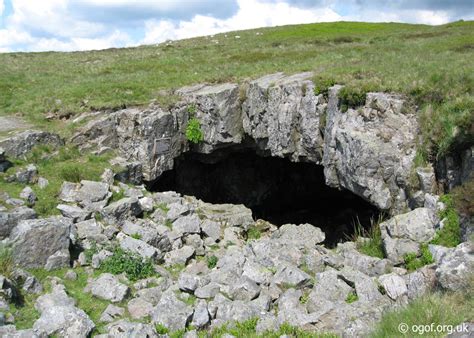 The arched gritstone entrance to Chartist Cave