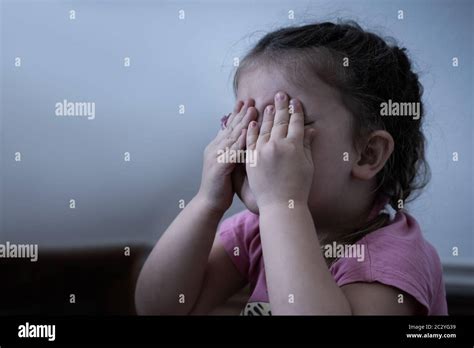 Little Girl Crying. Very Sad Girl Covering Her Eyes Stock Photo - Alamy