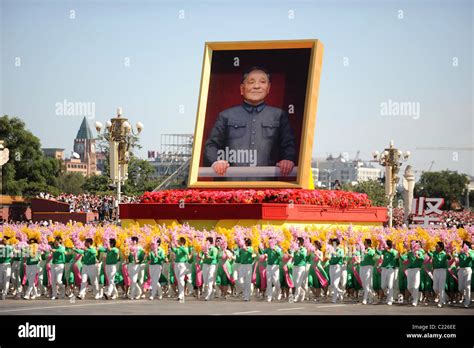 A large portrait of Chinese Communist leader, Deng Xiaoping drives past ...