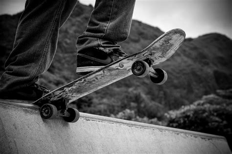 Person Standing on Skateboard Grayscale Photography · Free Stock Photo