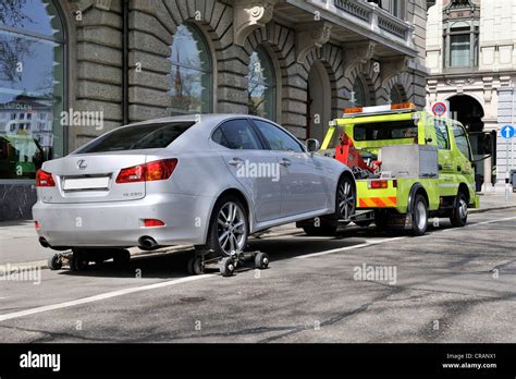 A car is being towed away from a no-parking zone in the historic ...