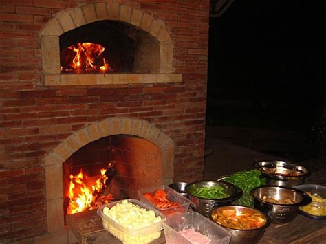 Mto brick oven with fireplace under a hut