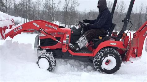 Compact Kubota Tractor plowing nearly 2 feet of snow - YouTube