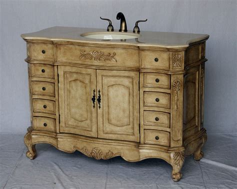 Antique style single sink bathroom vanity with beige color stone countertop and antique beige ...