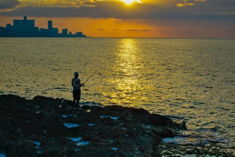 Silhouette of Man Fishing As Sunset Stock Photo - Image of rocks, shore ...