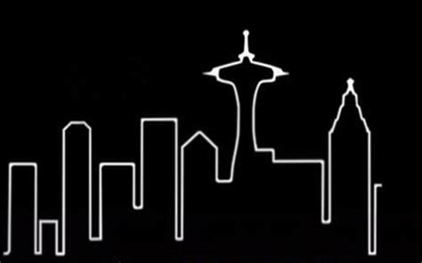 the seattle skyline is shown in white against a black background