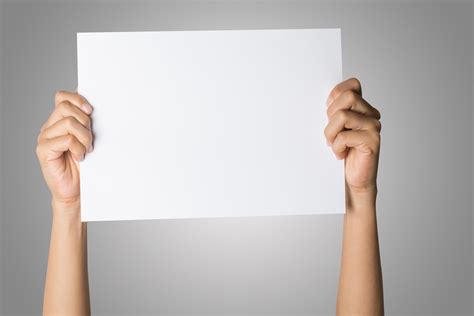 Close-up of a woman's hand holding blank paper isolated on white ...