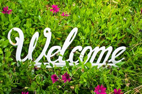 Metal White Welcome Sign On Flower Background Stock Photo - Download Image Now - iStock