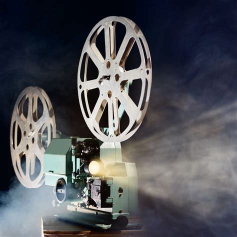 Old retro movie projector with smoke and light beam