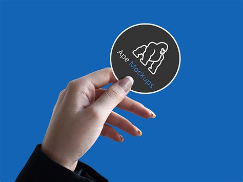 Free Sticker in Hand Mockup (PSD)