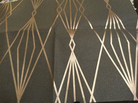 an art deco wallpaper design with gold and silver lines on black fabric, in a living room