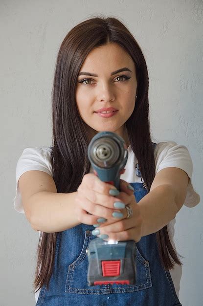 Premium Photo | A girl works with a cordless cordless drill screwdriver ...