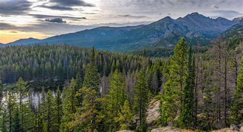 Green leafed trees overlooking mountain range with lake during day time ...