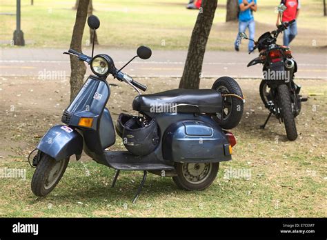 Bajaj motor scooter parked on the lawn in El Ejido Park on August 6, 2014 in Quito, Ecuador ...