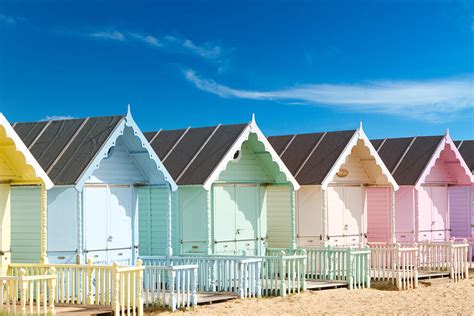 Traditional British Beach Huts On A Bright Sunny Day Photograph by ...