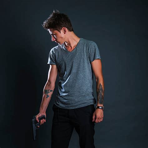 30+ Tattooed Man Holding A Pistol Stock Photos, Pictures & Royalty-Free ...