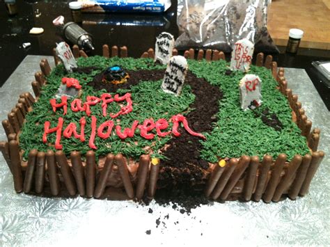 Halloween graveyard cake I made for a party. The dirt is oreos, with a chocolate finger fenc ...