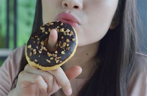 Premium Photo | Closeup photo of food in mouth eating food