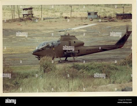 A United States army Cobra Gunship attack helicopter AH-1G sits on a landing strip during the ...