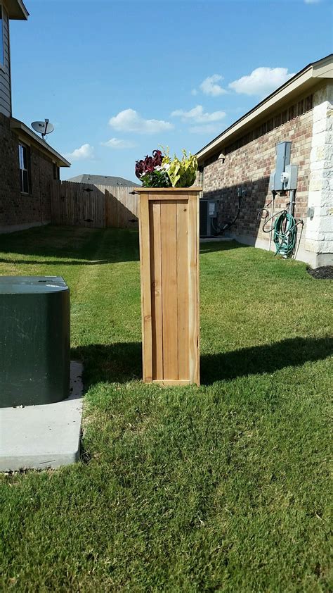 I covered my ugly utility pole with a tall planter style box made out ...