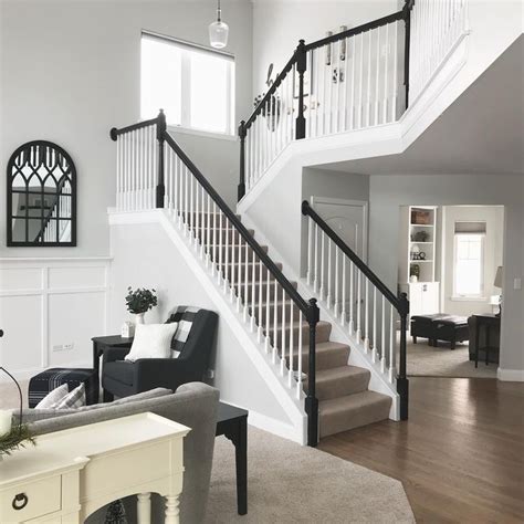 Open Staircase with White Spindles and Black Handrail in Modern Living Room