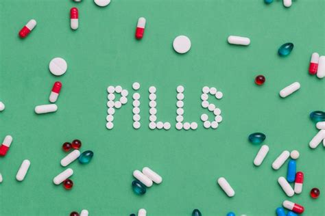 Free Photo | Colorful pills on green background