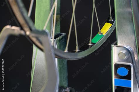 Bicycle repair. The front wheel is on a stand on a black background. Rim and spokes close-up ...