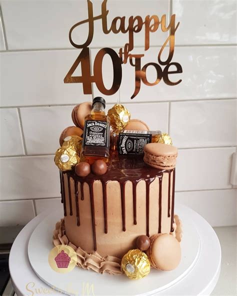 a birthday cake with chocolate and candies on top that says happy 40 three