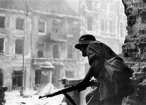 WWII --- Polish resistance fighter equipped with captured German helmet and rifle (Warsaw ...