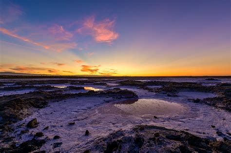 A Lighthouse near the Beach during Sunset · Free Stock Photo