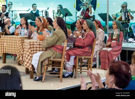 Cypriot people in traditional dress watch performers at the Statos ...