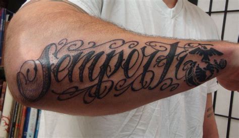 a man with a tattoo on his arm has the word dragon written in cursive ...