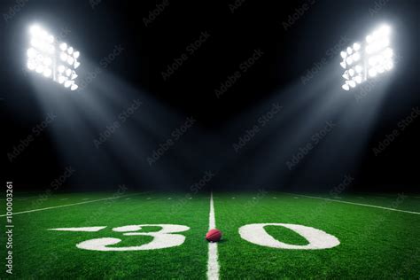 Football field illuminated by stadium lights Stock Photo | Adobe Stock