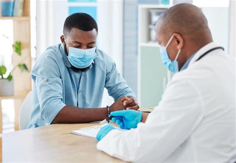 Premium Photo | Doctor covid and black man in consultation for results on clipboard in hospital ...