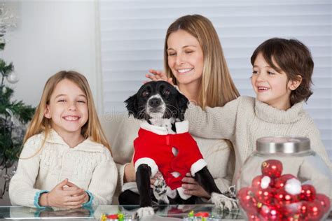 Family With Pet Dog At Home During Christmas Royalty Free Stock Photo - Image: 35885595